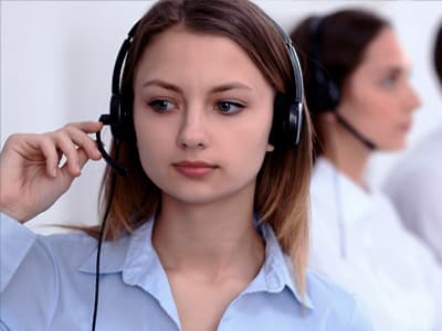 concerned woman in headset at PTSD hotline center