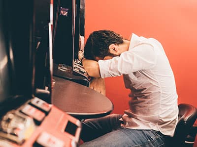 Man slumped on slot machine, gambling loss
