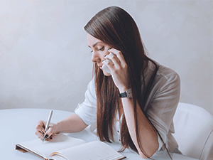 woman making a phone call and taking notes