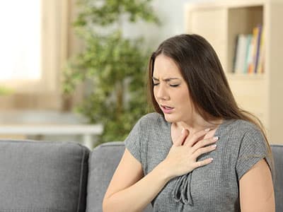 woman holding chest looking hurt, concept of withdrawal