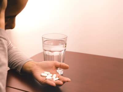 Woman looking at pills
